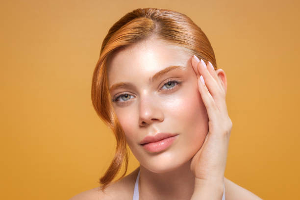 Woman with glowing skin on a yellow background