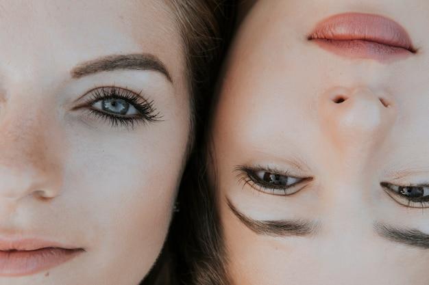 Close-up of two women's faces lying side by side, highlighting their eyes and facial features