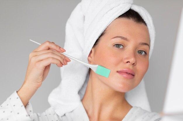 Woman using facial skincare tool